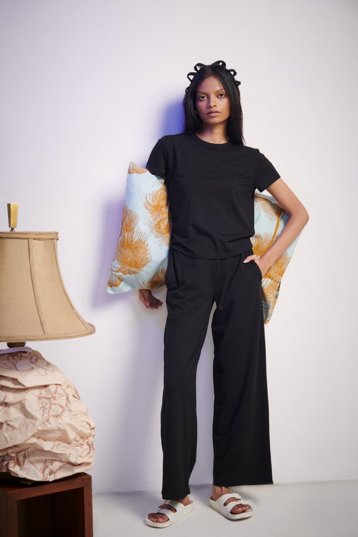 Model wearing a Black Supima® T-Shirt with stylish decor.