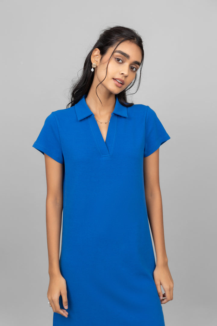 Blue mini waffle short polo dress modeled by a woman.