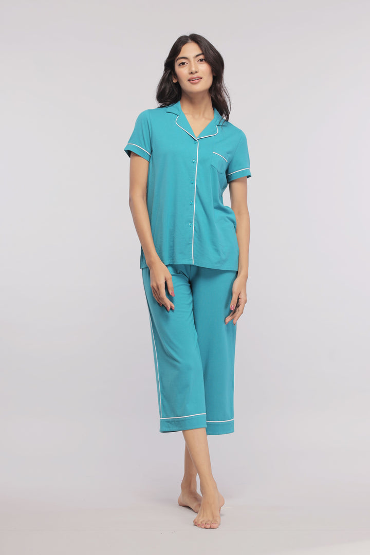 Teal capris with white piping, styled with a matching shirt.