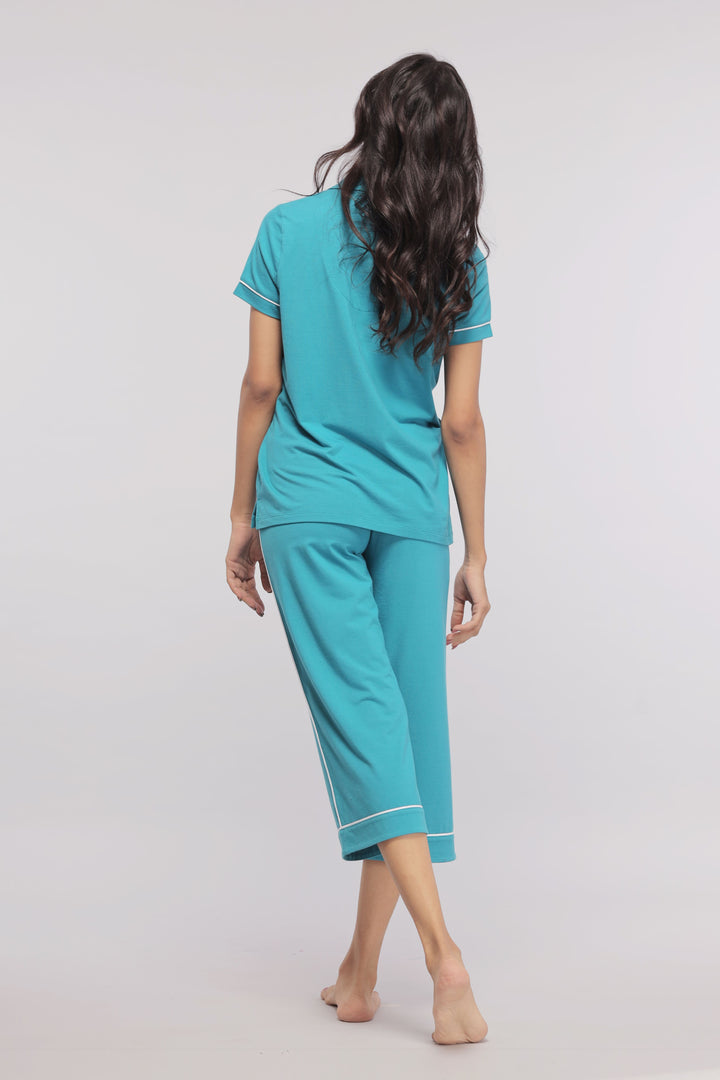 Teal capris with white piping, stylish and comfortable, perfect for relaxation.