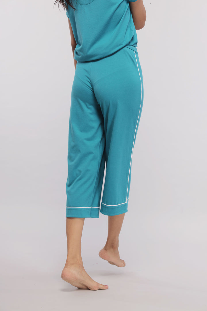 Teal capris with white piping, perfect for casual comfort.