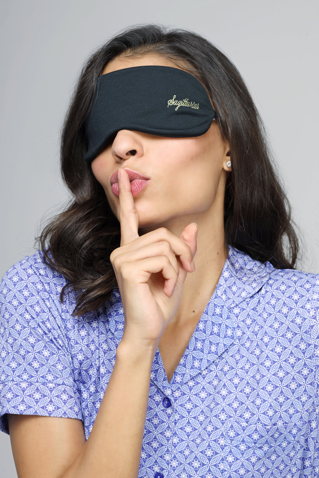Sagittarius eye mask worn by a woman, promoting relaxation and sleep.