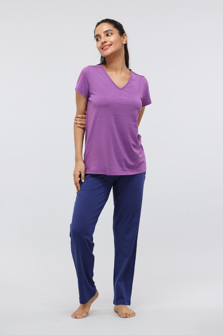 Meadow Violet Supima® V Neck Casual Top worn with navy pants.