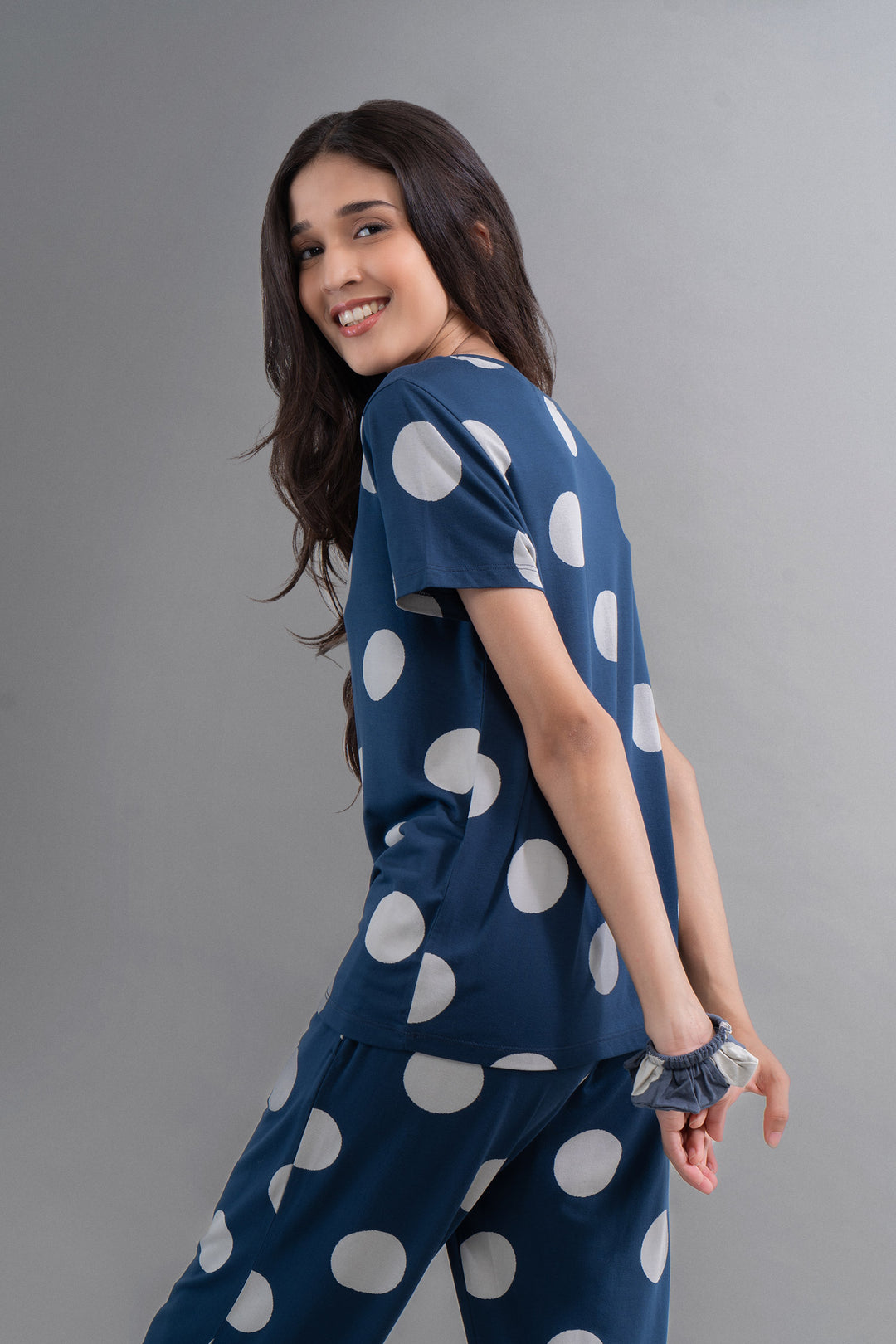 Sleepy Navy Polka Supima Pajama Set displayed by model, smiling and stylish.