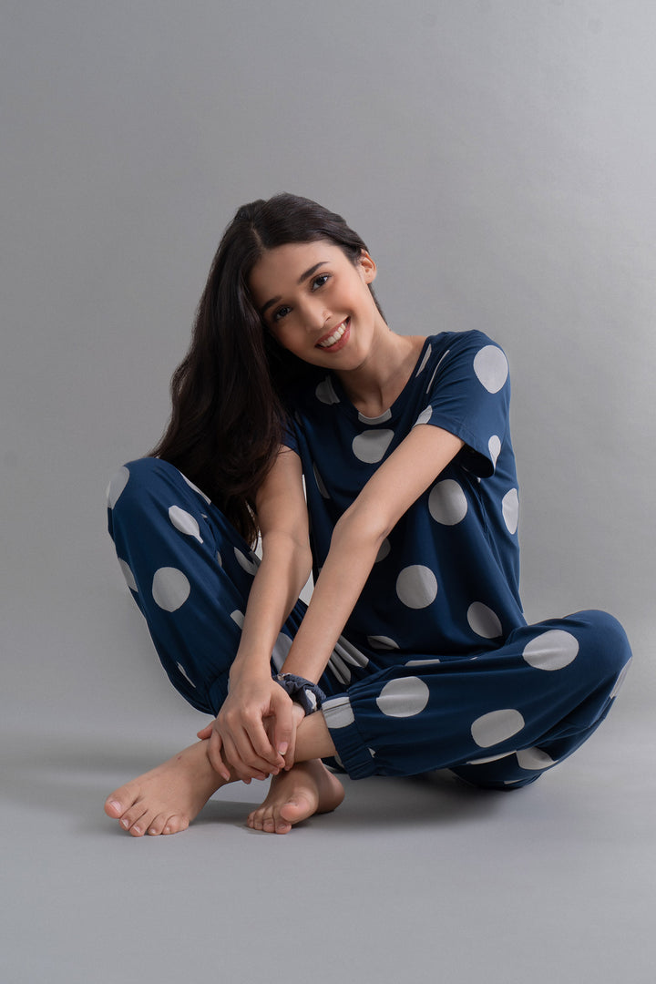 Sleepy Navy Polka Supima Pajama Set modeled by a smiling woman.