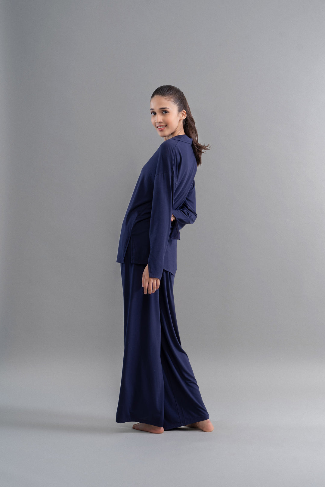 Deep navy Supima flared pajamas model standing gracefully.