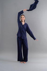 Stylish woman wearing Supima button down pajama set in navy blue.
