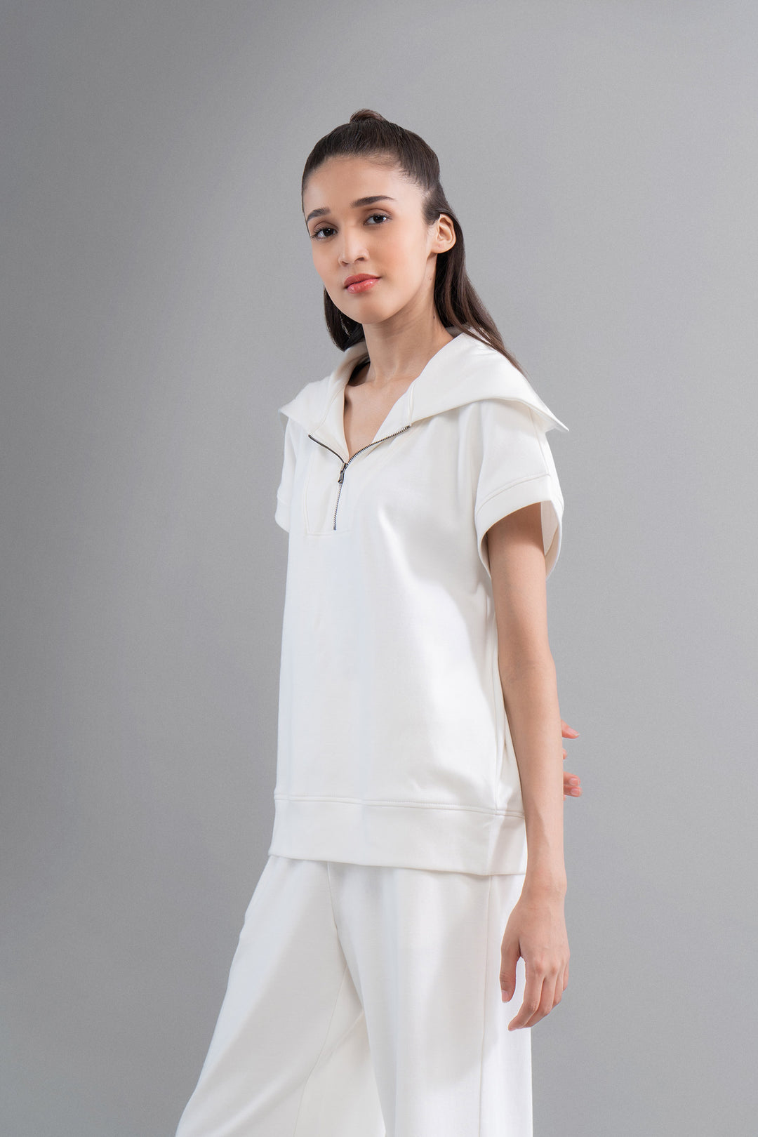Model showcases Snugknit® Ivory Polo Top in stylish setting.