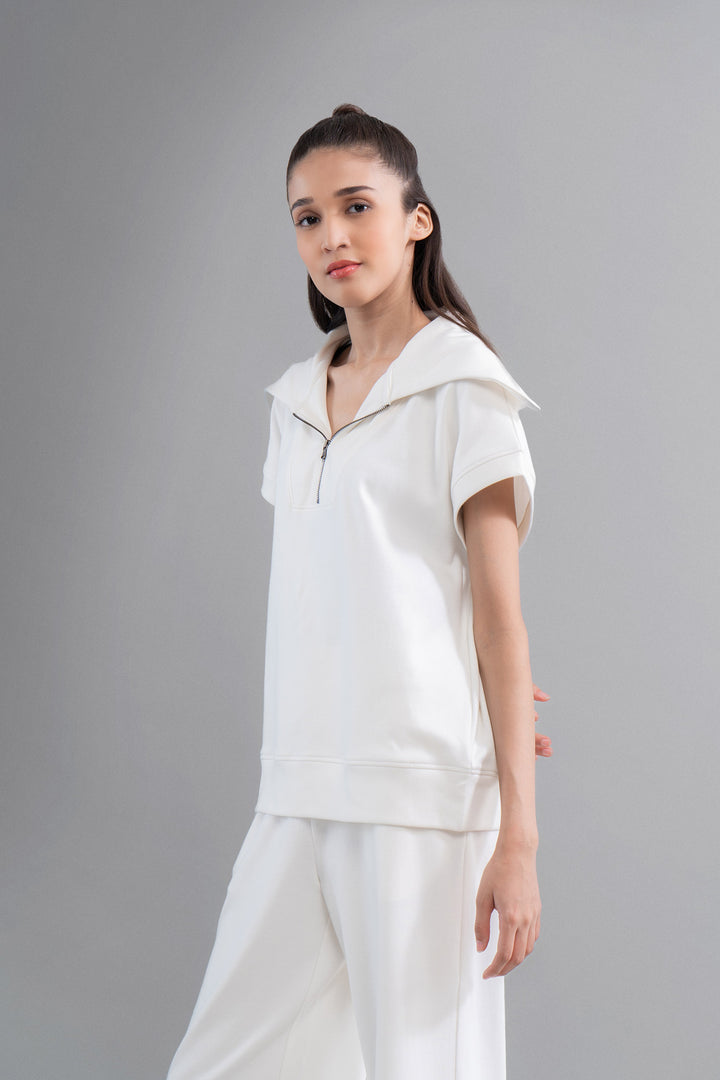 Model showcases Snugknit® Ivory Polo Top in stylish setting.