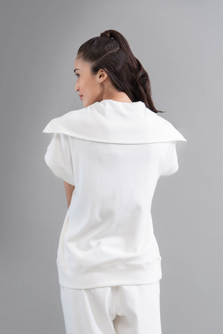 Woman wearing Snugknit® Ivory Polo Top, stylish back view.