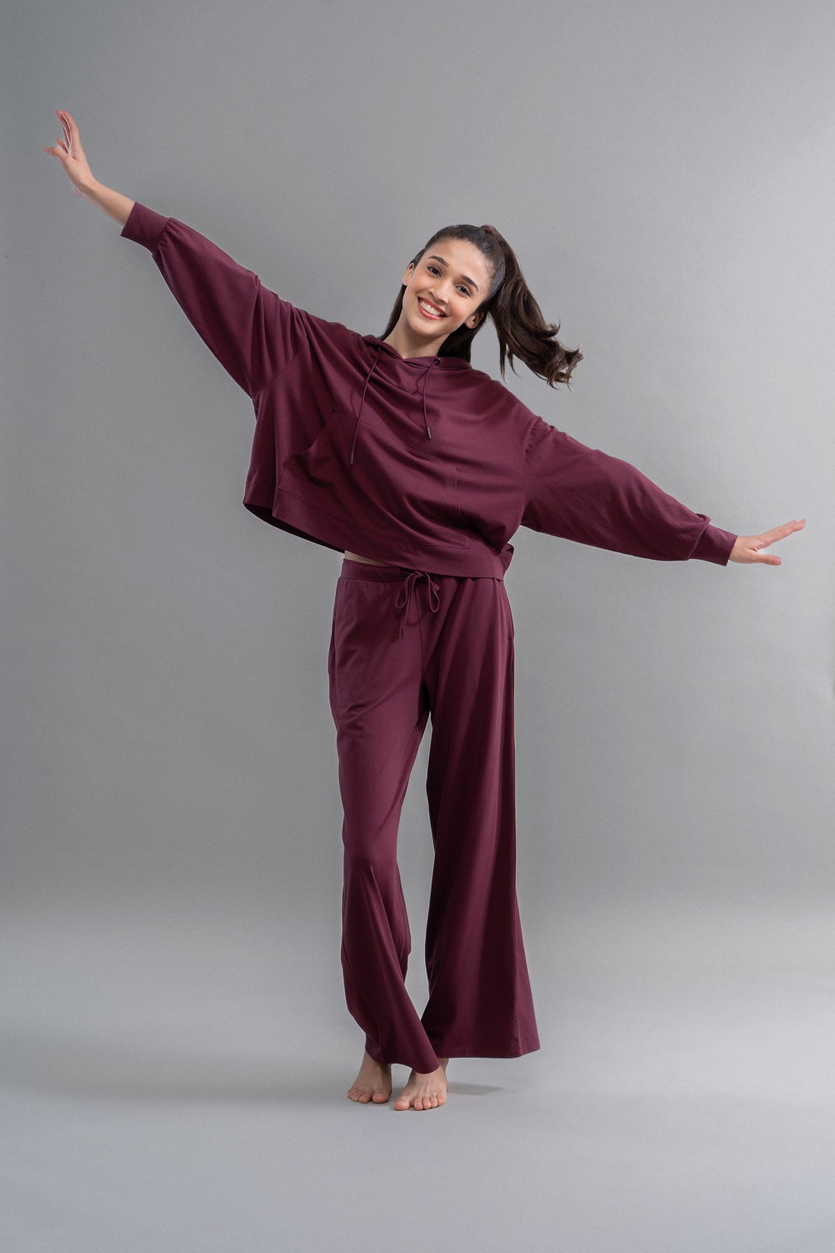 Model in maroon Luxflo® Travel Hoodie Set, showcasing comfort and style.