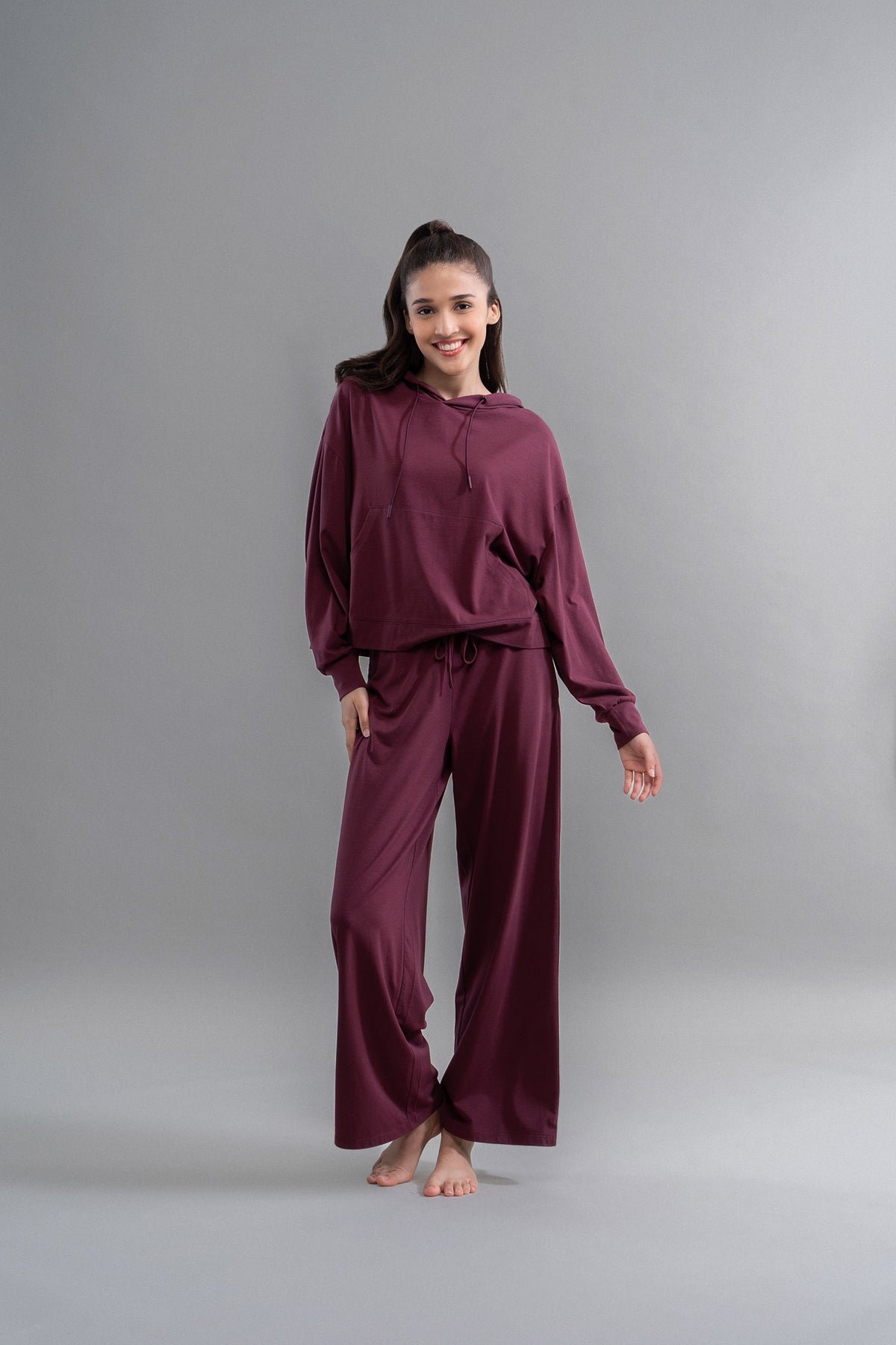 Limited Edition Luxflo® Travel Hoodie Set model in burgundy outfit.