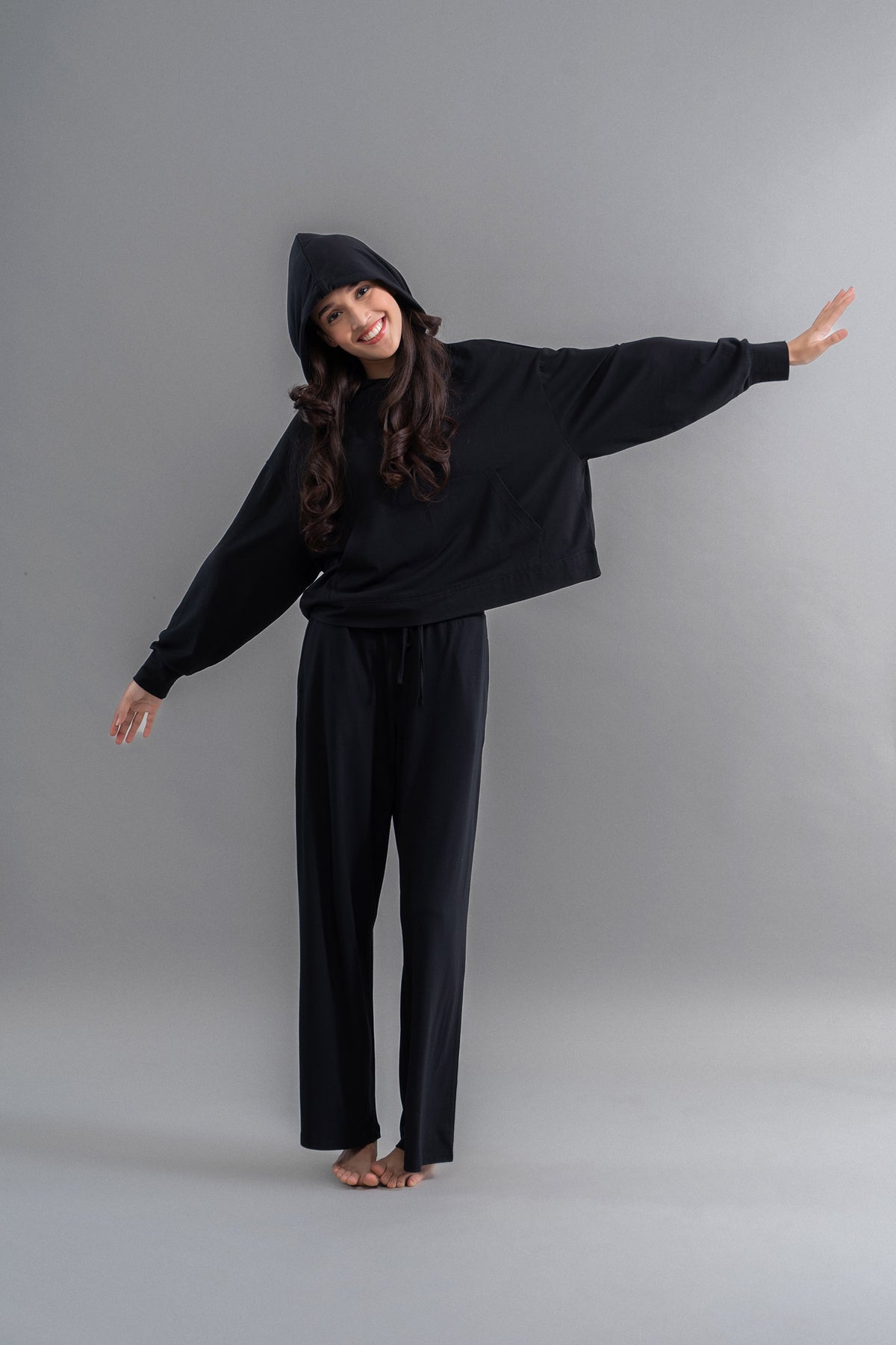 Limited Edition Luxflo® Travel Hoodie Set model showcasing stylish black outfit.