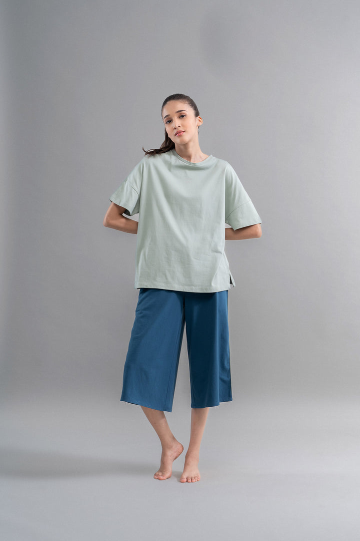 Sage teal cotton culottes worn by a model on a neutral background.
