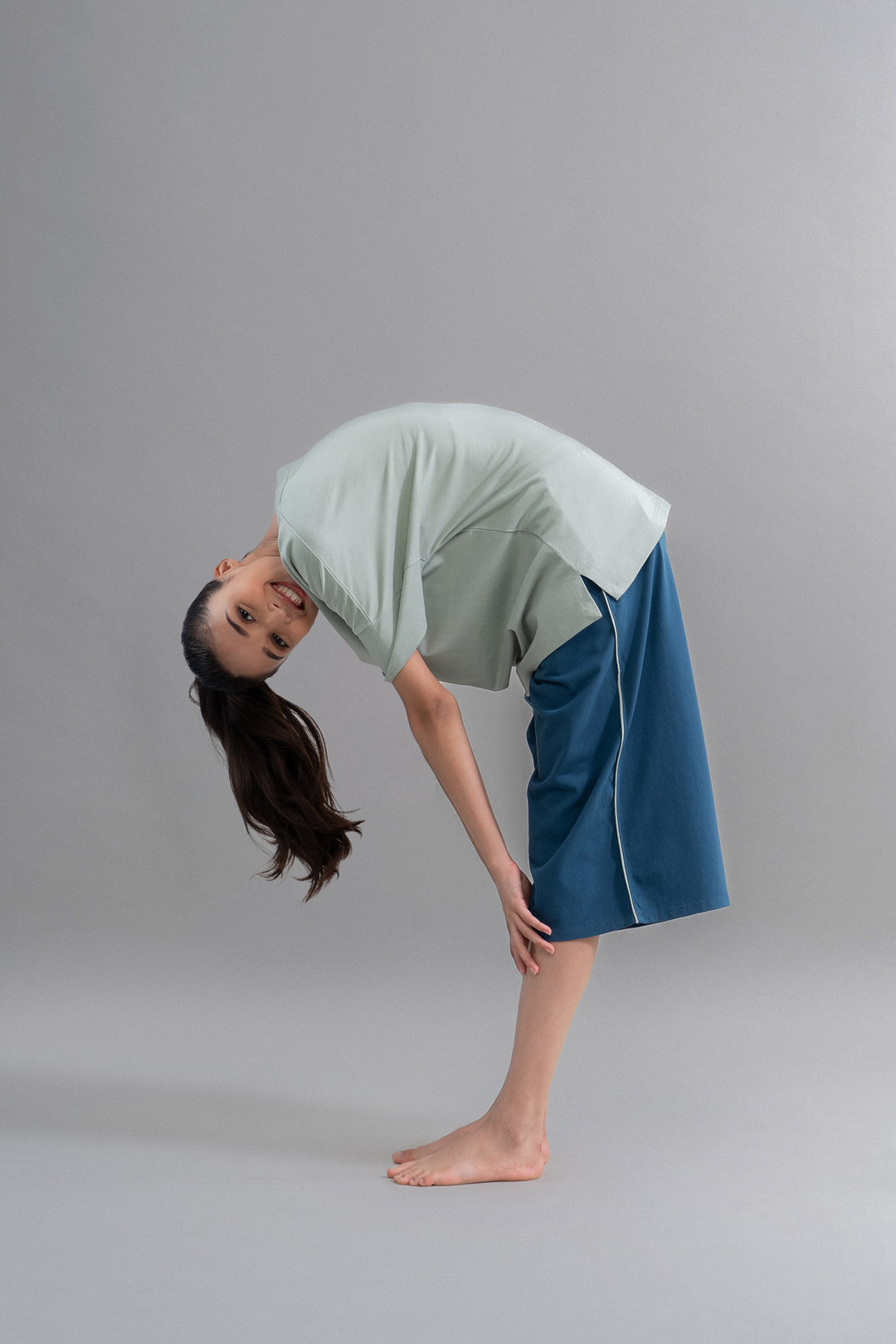 Model showcasing sage teal cotton culottes with relaxed fit and style.