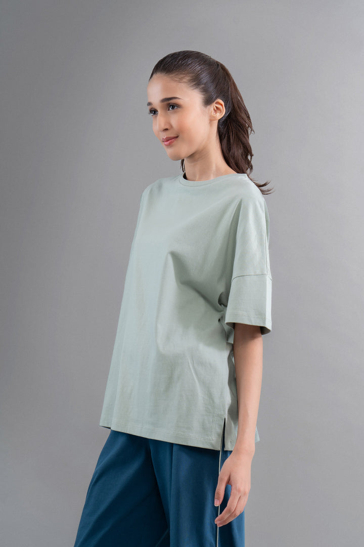 Sage cotton side slit t-shirt styled with relaxed fit and comfort.