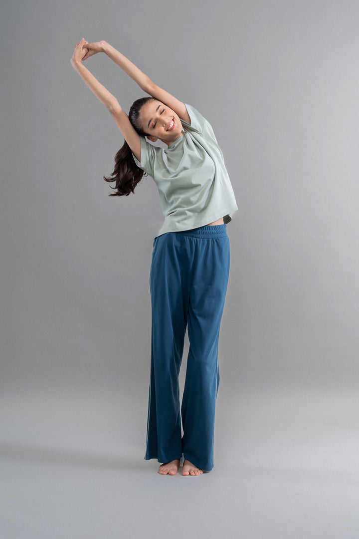 Sage teal cotton lounge pants with contrast piping in relaxed styling.