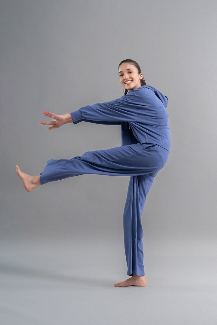Smiling woman posing in Limited Edition Luxflo® Travel Blue Flared Pajamas.