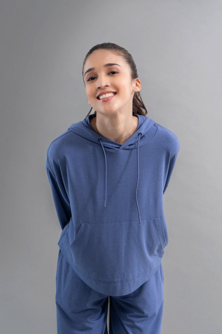 Model wearing a limited edition Luxflo® travel blue hoodie.
