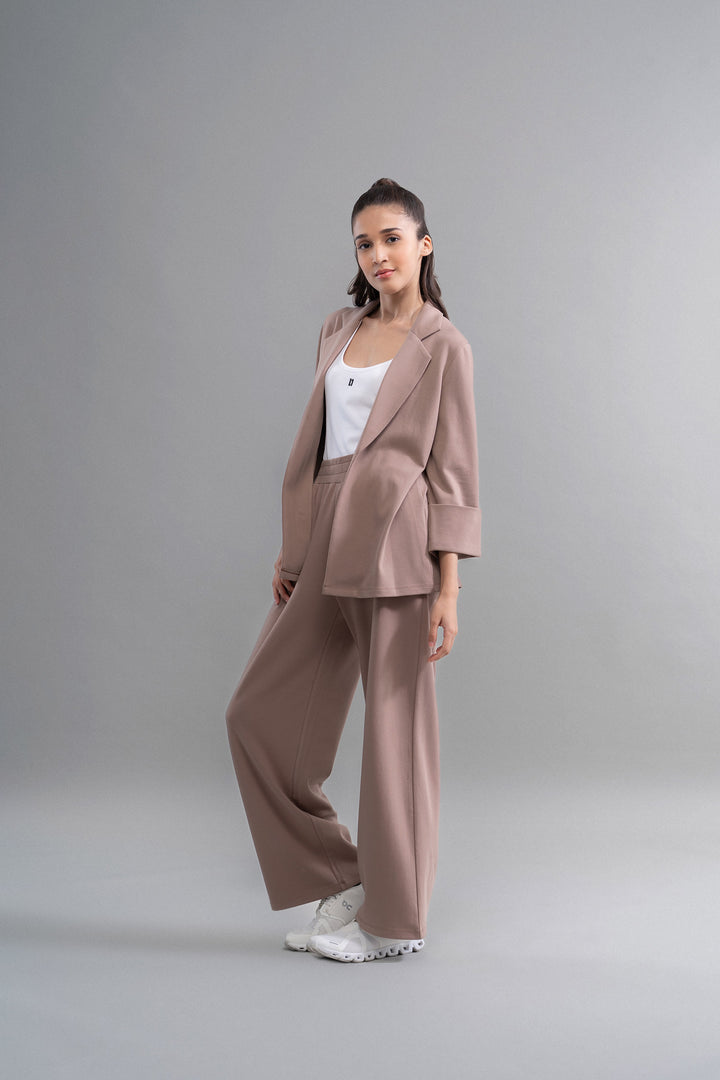 Snugknit® Mocha Blazer modeled with matching pants and white sneakers.