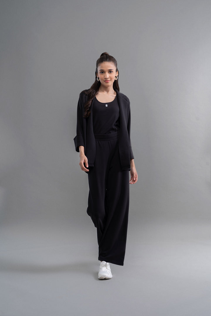 Model showcasing Snugknit® Blazer Set in stylish black outfit.