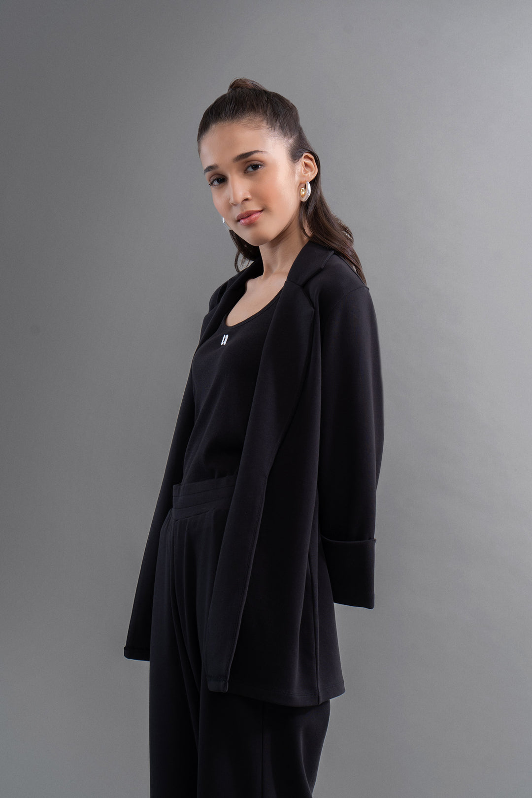 Elegant woman wearing Snugknit® Black Blazer, showcasing modern style.