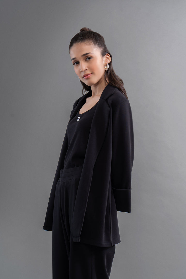 Elegant woman wearing Snugknit® Black Blazer, showcasing modern style.