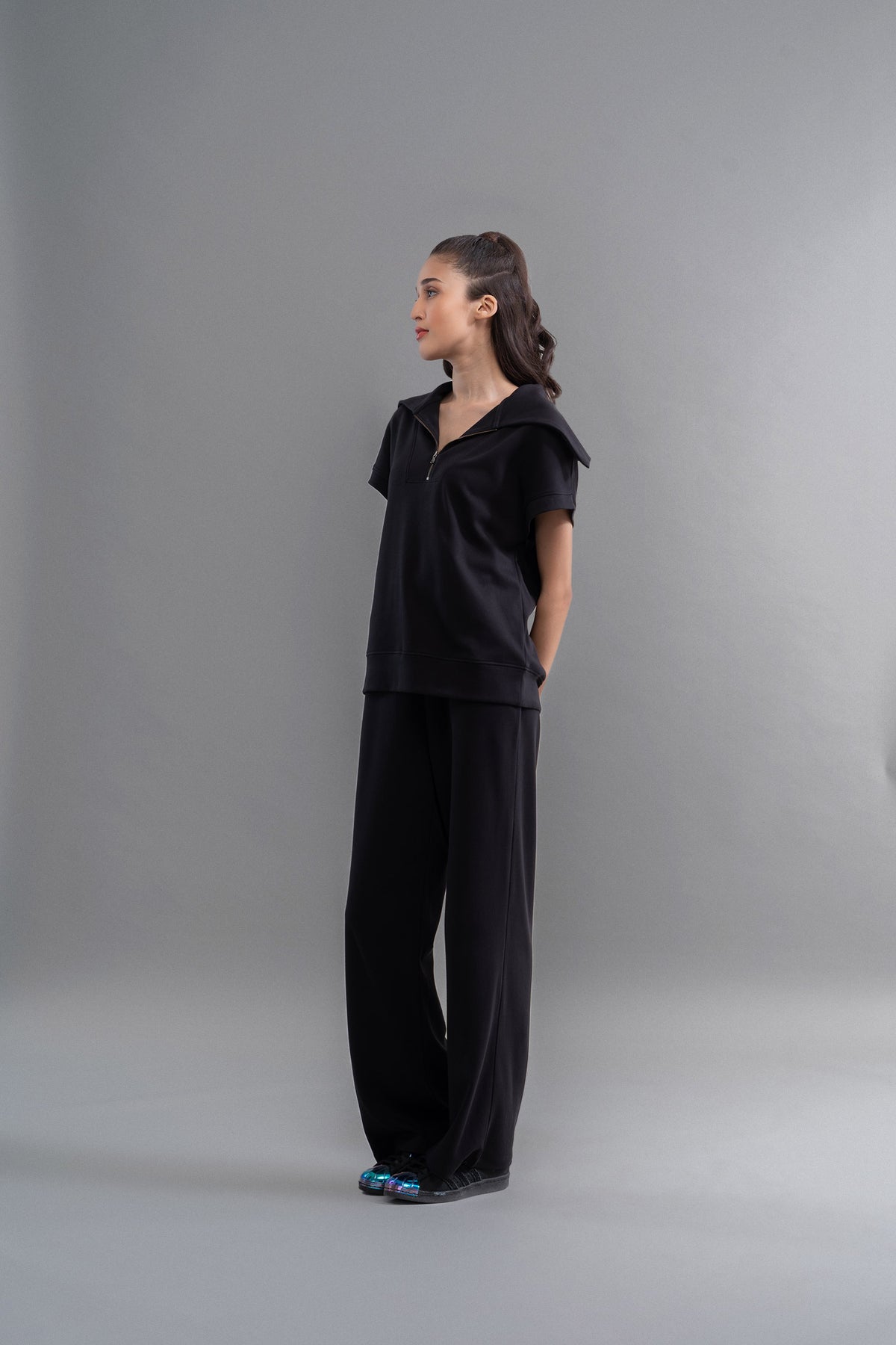 Snugknit® black flared pant showcased on a model against a gray background.