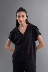 Snugknit® black polo top on model, stylish and comfortable design.