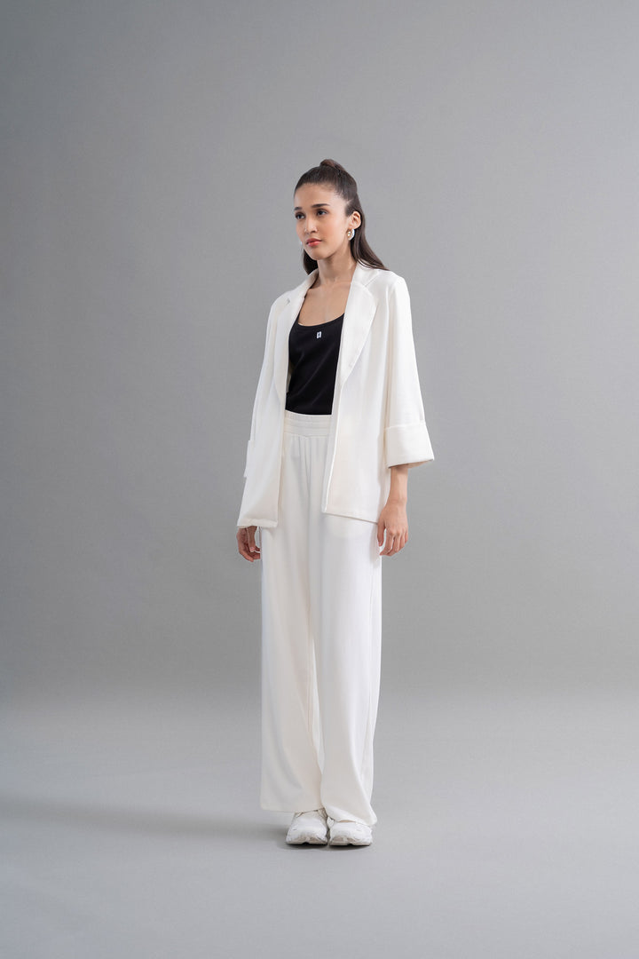 Model wearing Snugknit® ivory blazer with matching pants and black top.