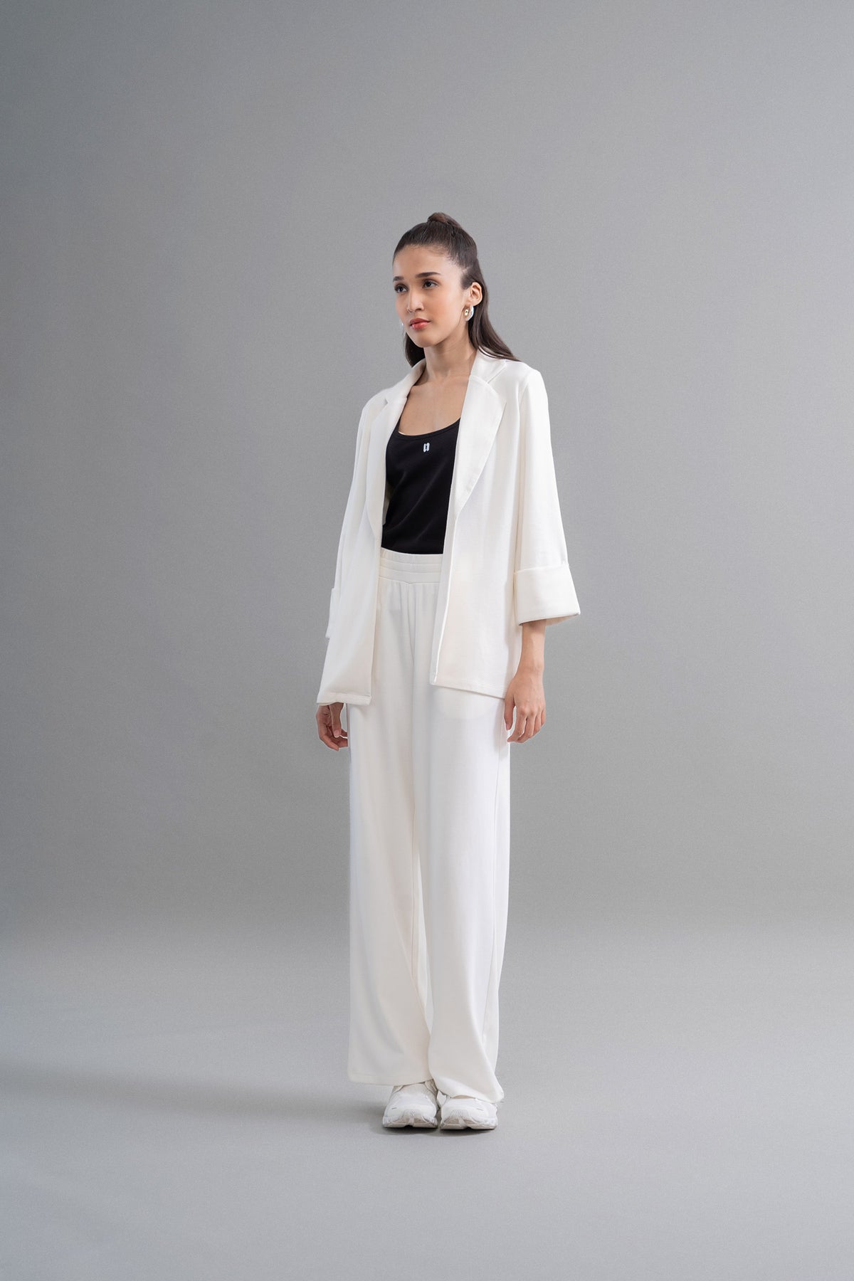 Model wearing Snugknit® Ivory Flared Pant with black top.