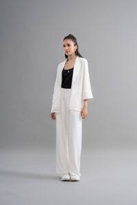 Snugknit® ivory flared pant with black tank top model photo.