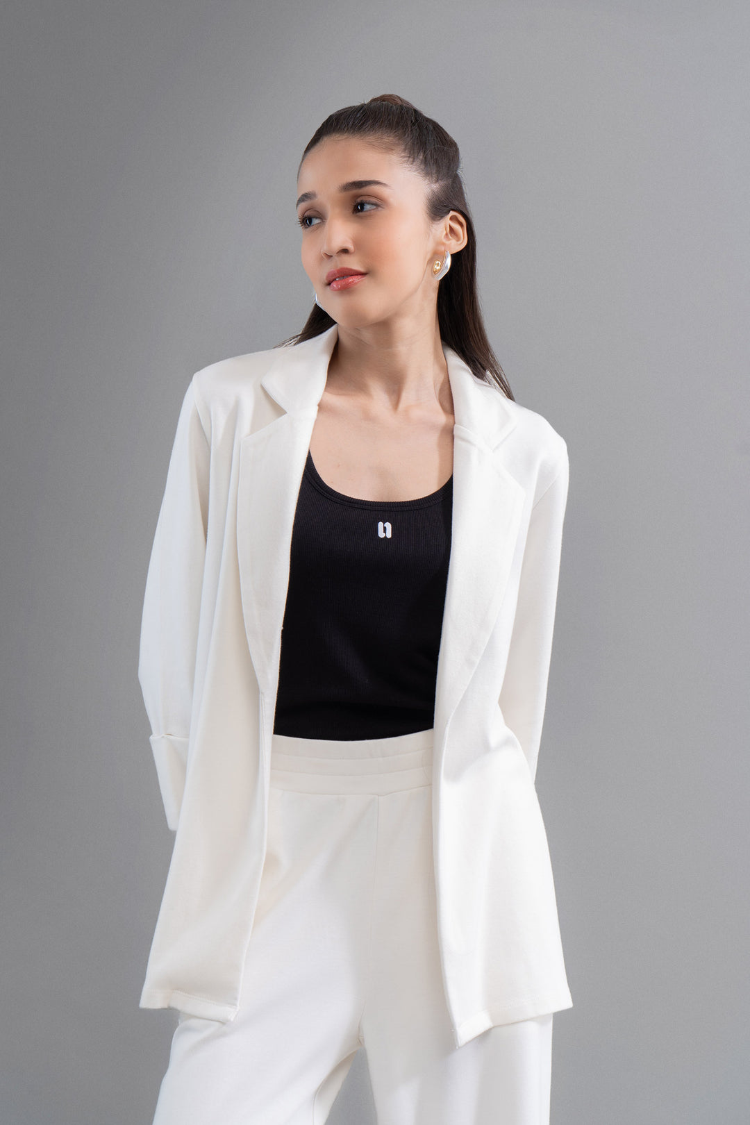 Model wearing Snugknit® Ivory Blazer with black top, stylish look.