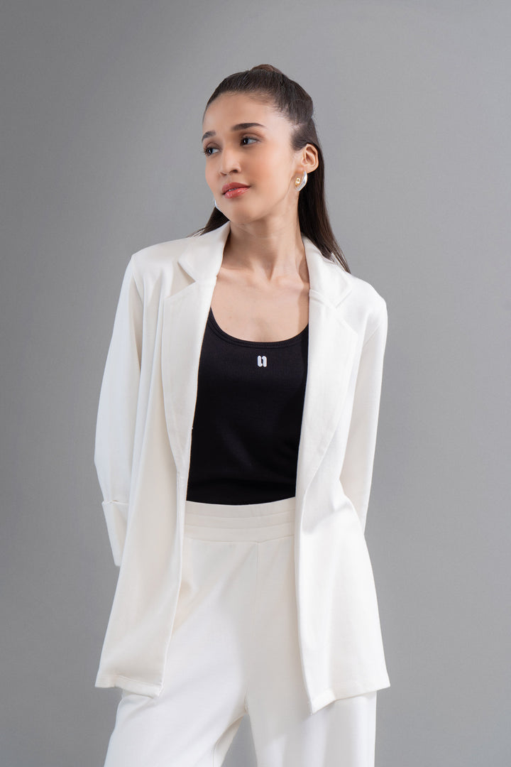Model wearing Snugknit® Ivory Blazer with black top, stylish look.