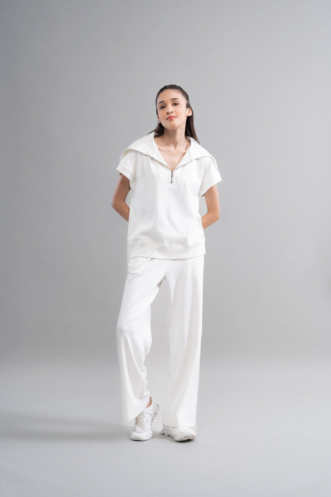 Snugknit® ivory flared pant paired with matching top and sneakers.