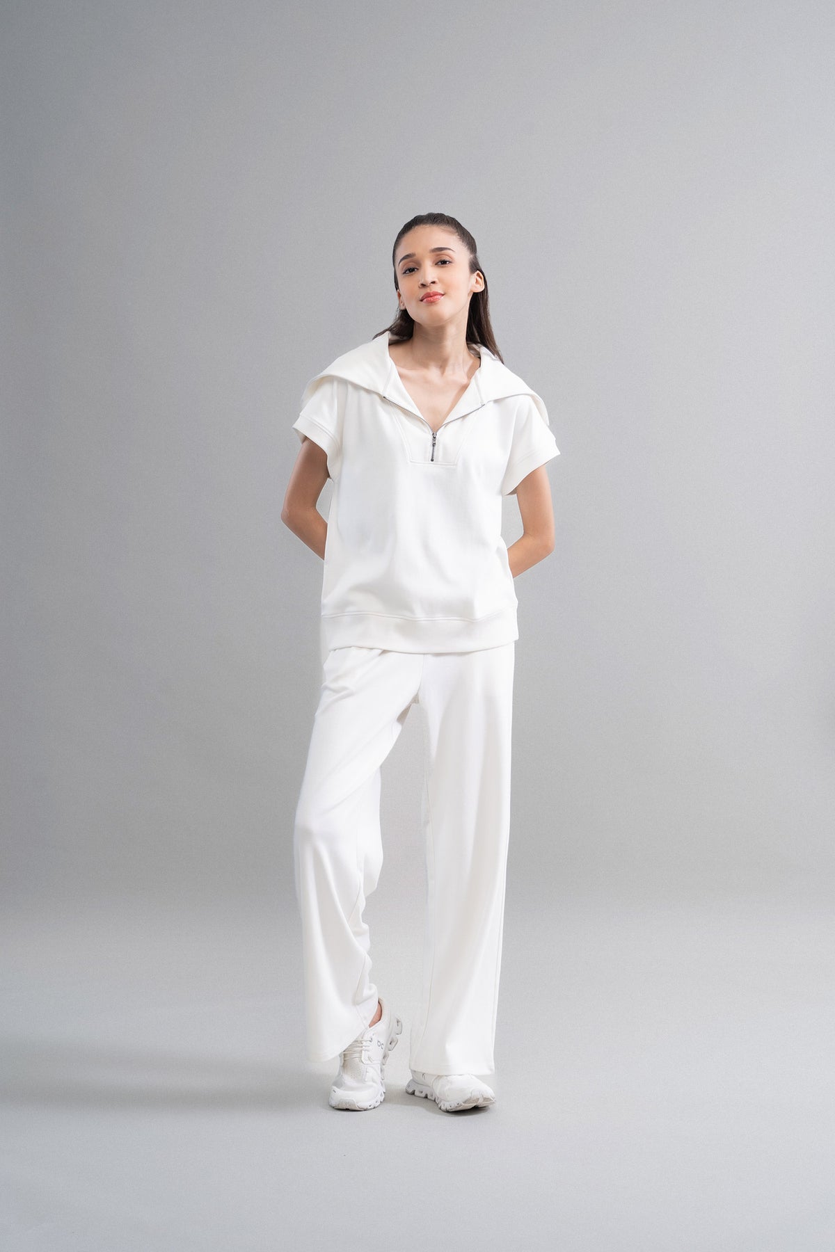 Snugknit® ivory flared pant paired with matching top and sneakers.