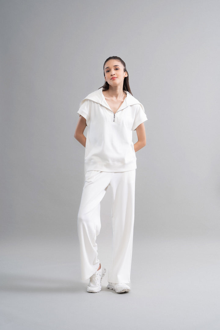 Snugknit® ivory flared pant paired with matching top and sneakers.