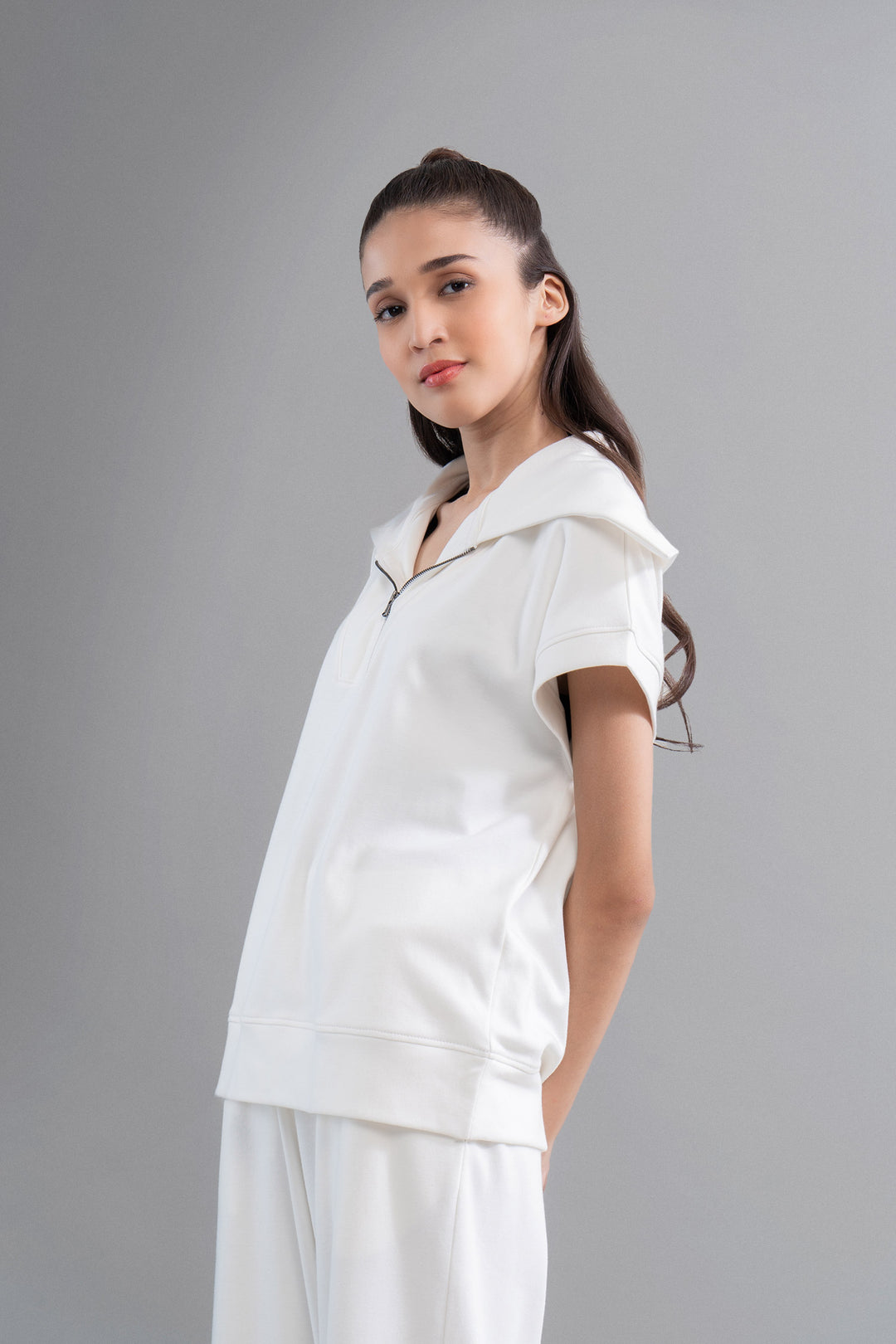Snugknit® ivory polo top on model with stylish hood.