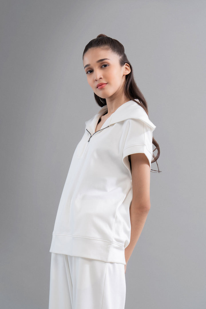 Snugknit® ivory polo top on model with stylish hood.