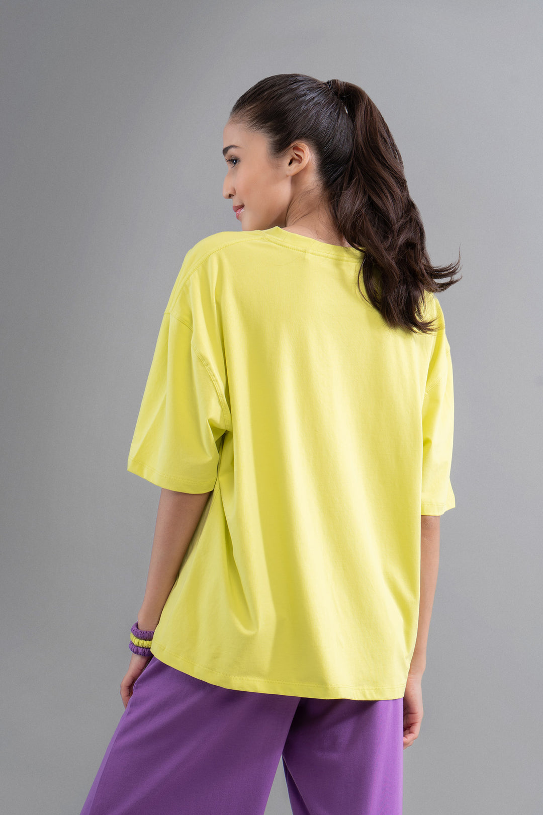 Model wearing Lime Purple Unisex T-Shirt with relaxed fit and vibrant colors.
