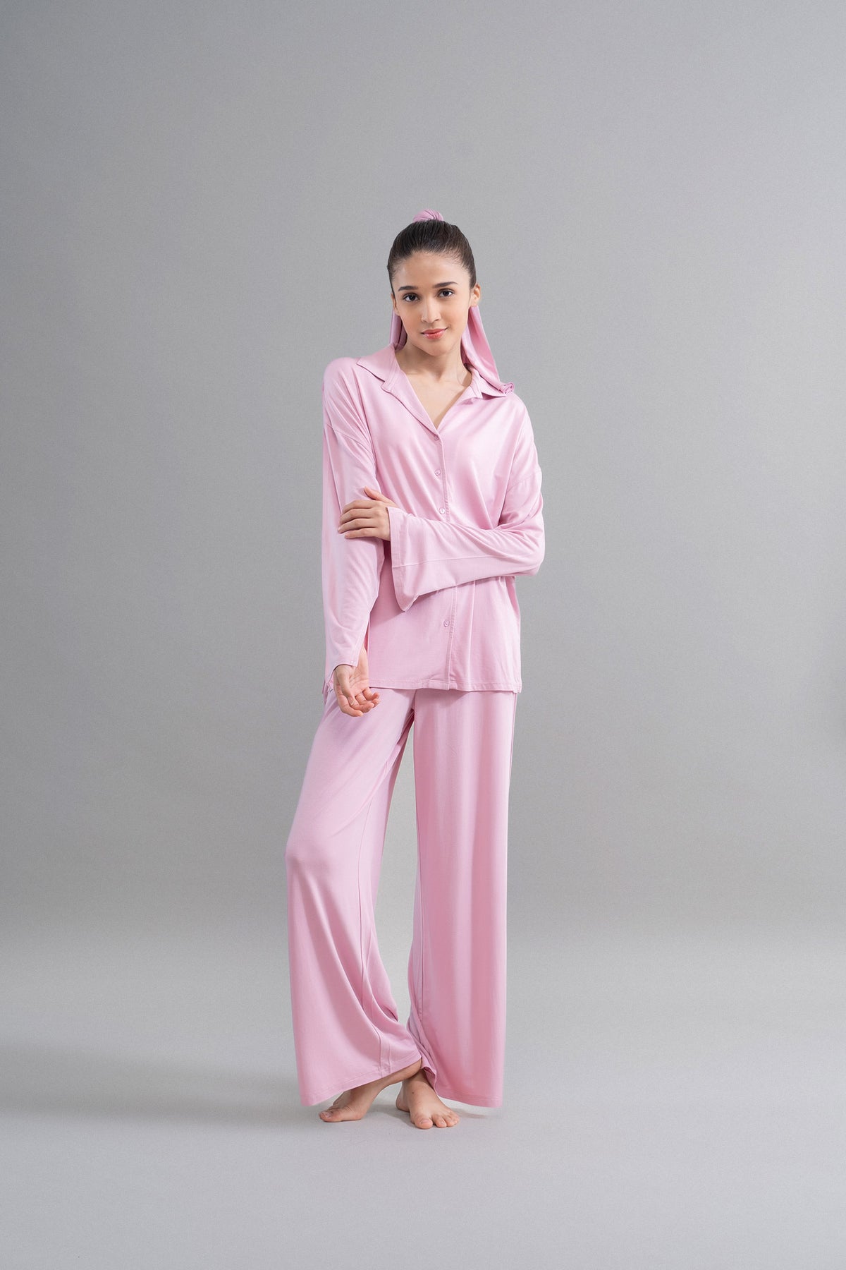 Deep pink modal button down pajama set modeled by a young woman.