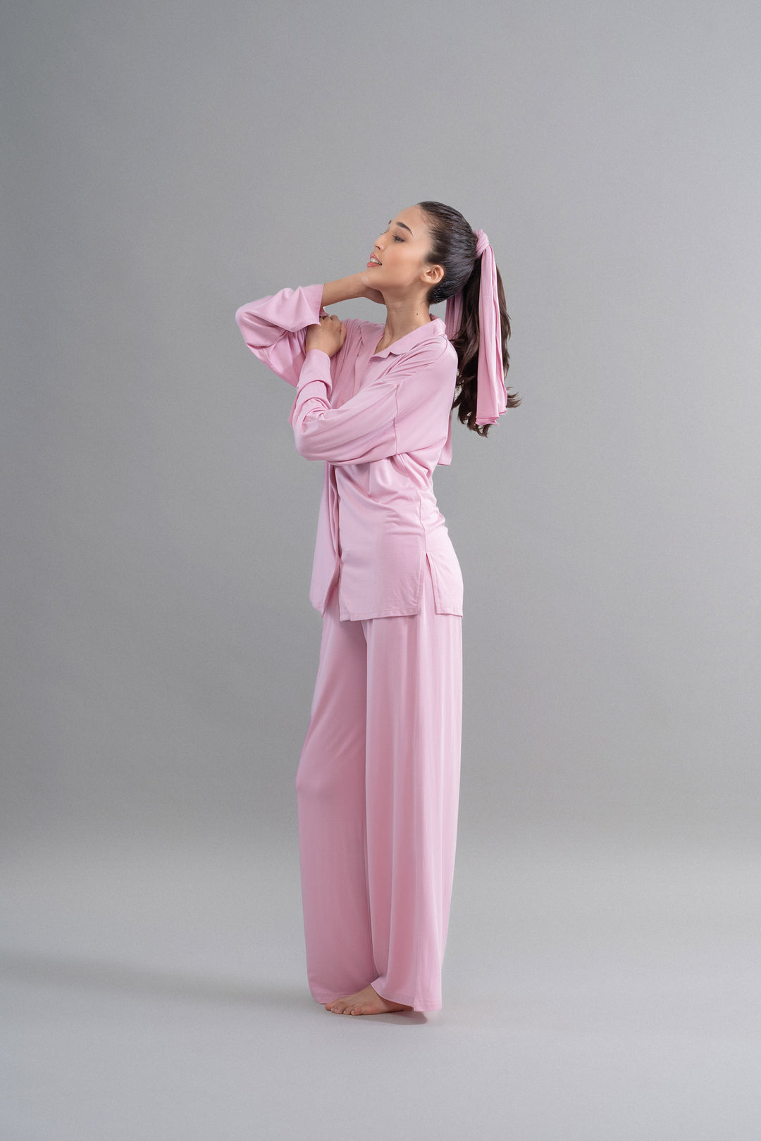 Deep pink modal button-down pajama set on model against grey background.