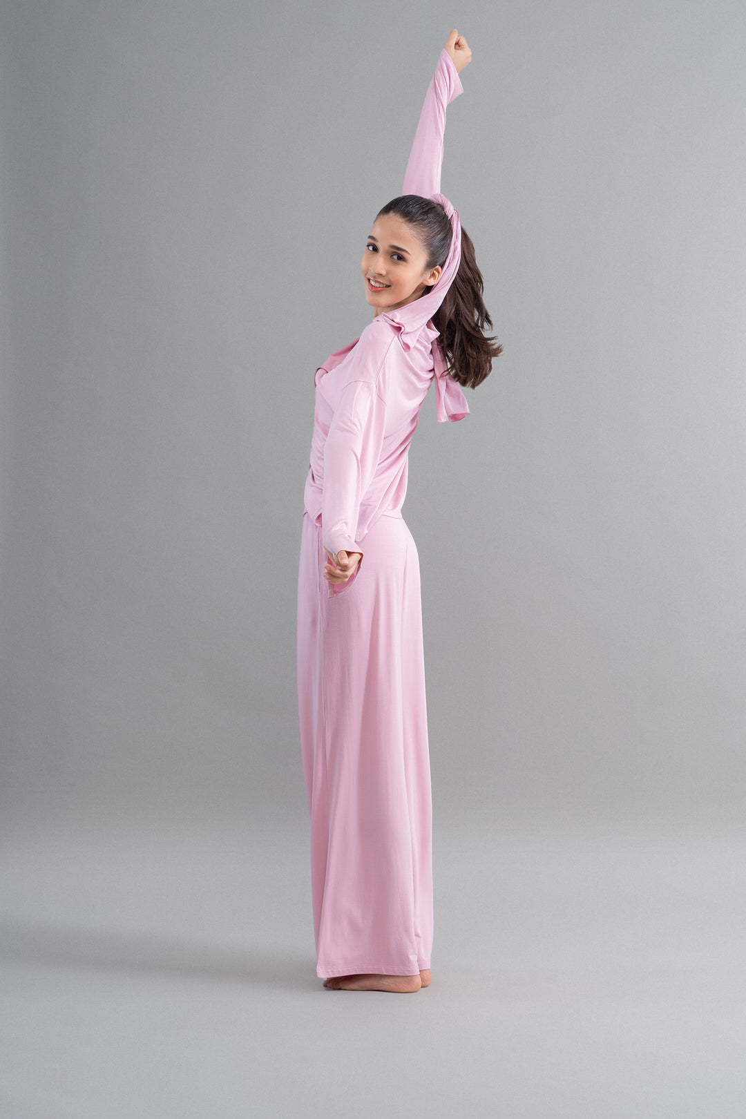 Deep pink modal button-down pajama set model posing cheerfully.