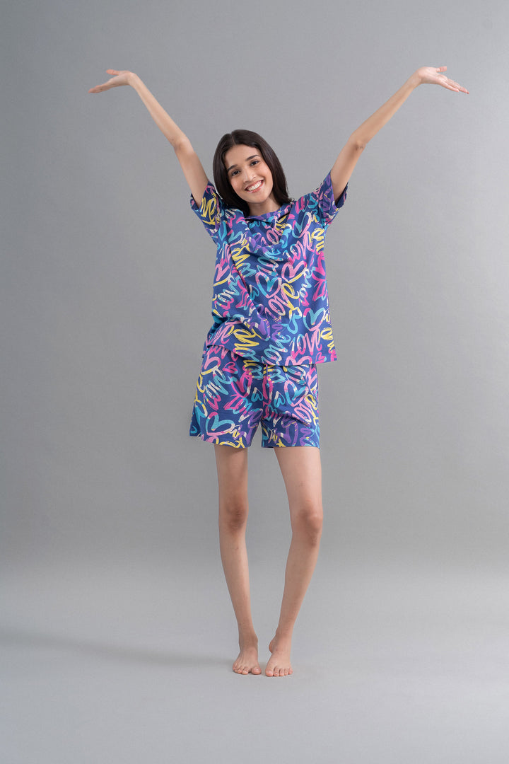 Cozy Heart Cotton Blue Oversized Tee model in playful pose.