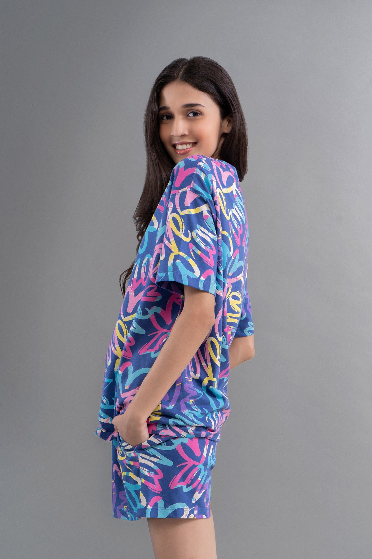 Model wearing Cozy Heart Cotton Blue Regular Shorts, vibrant print design.
