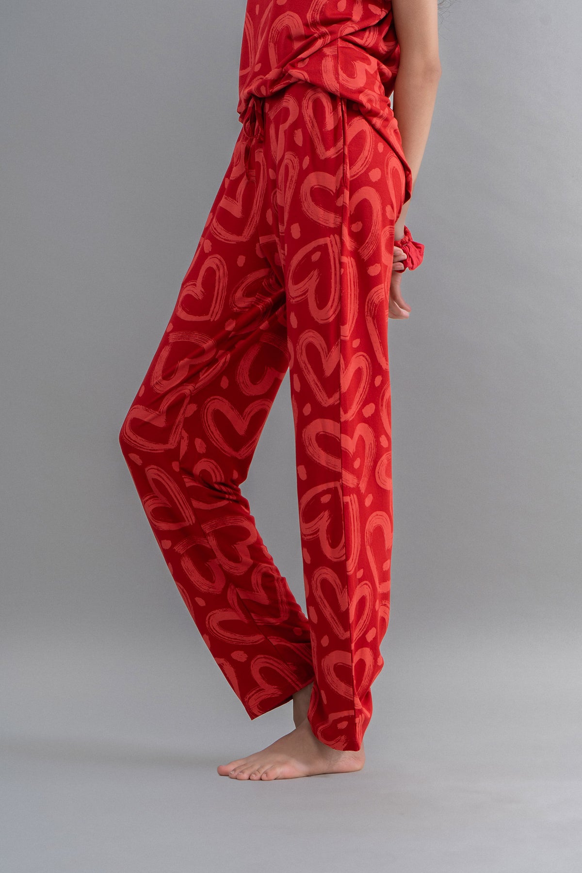 Lovestruck Hearts Red Pajamas on a model with playful heart patterns.