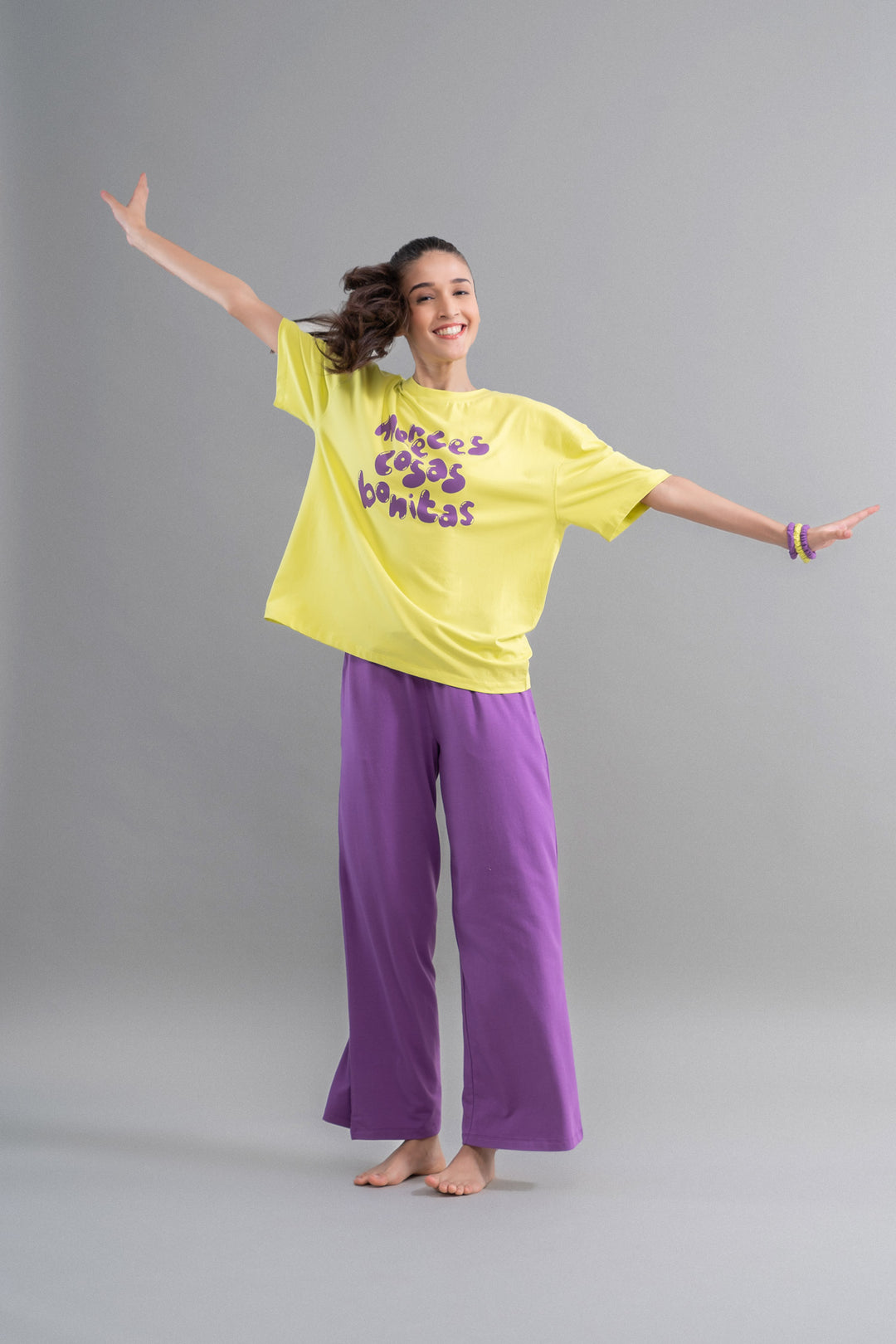 Model wearing Meadow Violet Supima flared pajamas in vibrant colors.
