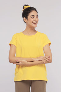 Sunny Lime Supima® round neck top on model, smiling in yellow.