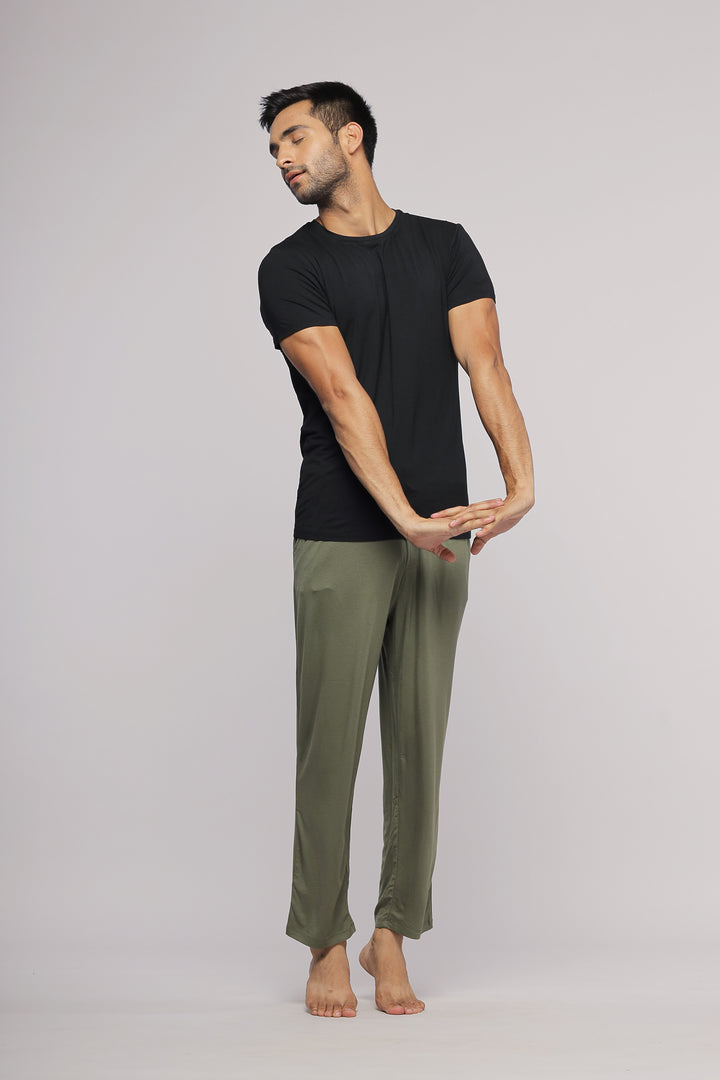 Black men's tee worn by model with olive pants.