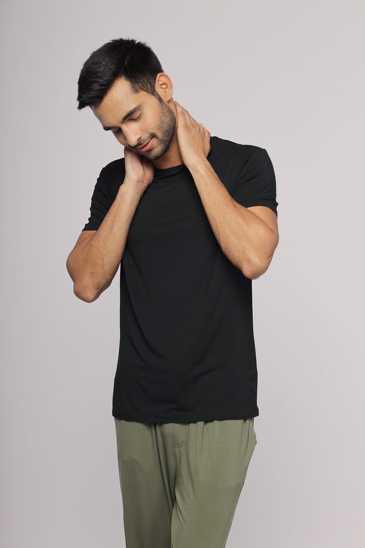 Black men's tee worn by model showcasing casual style.
